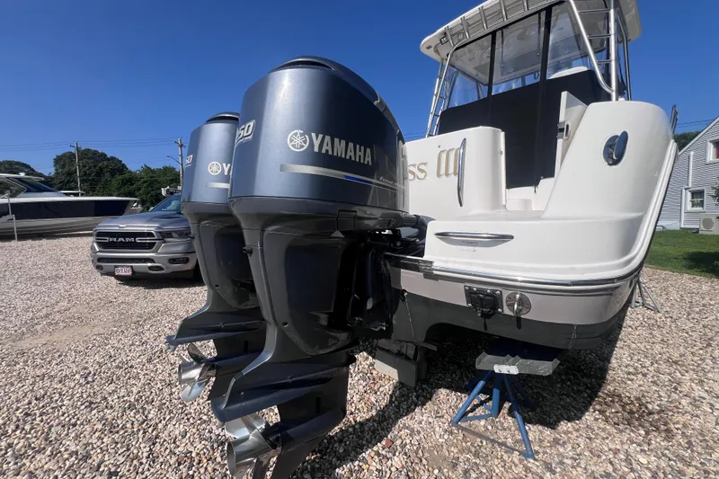 Slide: The Image of 2007 Robalo R305 Walkaround with Yamaha outboard motors on gravel lot. - 4
