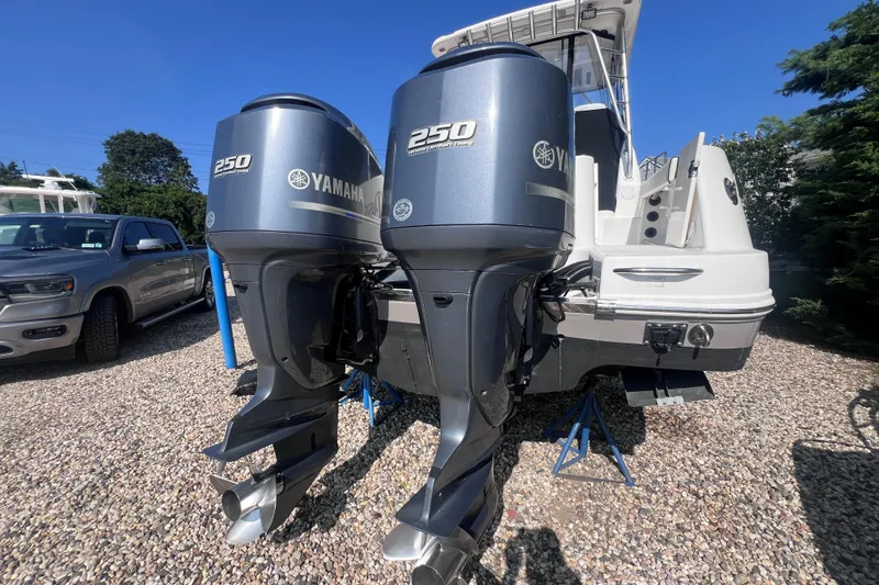Slide: The Image of 2007 Robalo R305 Walkaround with twin Yamaha 250 engines on gravel lot. - 5