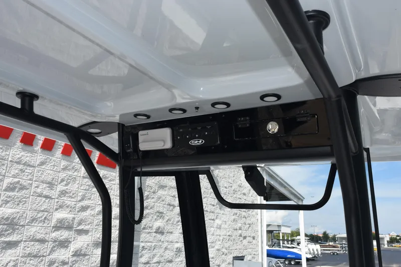 Slide: The Image of 2026 Sea Hunt Gamefish 25 boat console with electronic equipment and storage. - 10