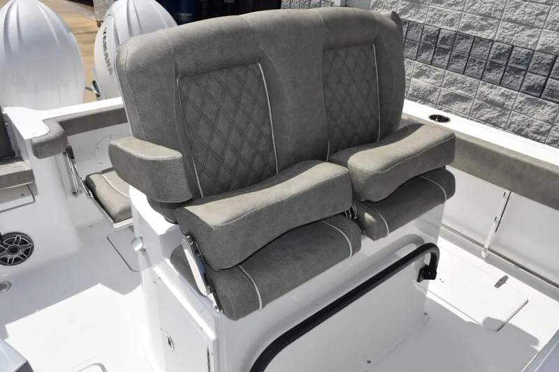Slide: The Image of 2026 Sea Hunt Gamefish 25 boat with cushioned seating and dual outboard motors. - 12
