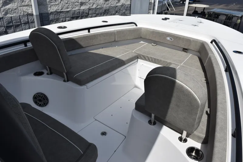 Slide: The Image of 2026 Sea Hunt Gamefish 25 boat interior with gray cushioned seating and modern design. - 13