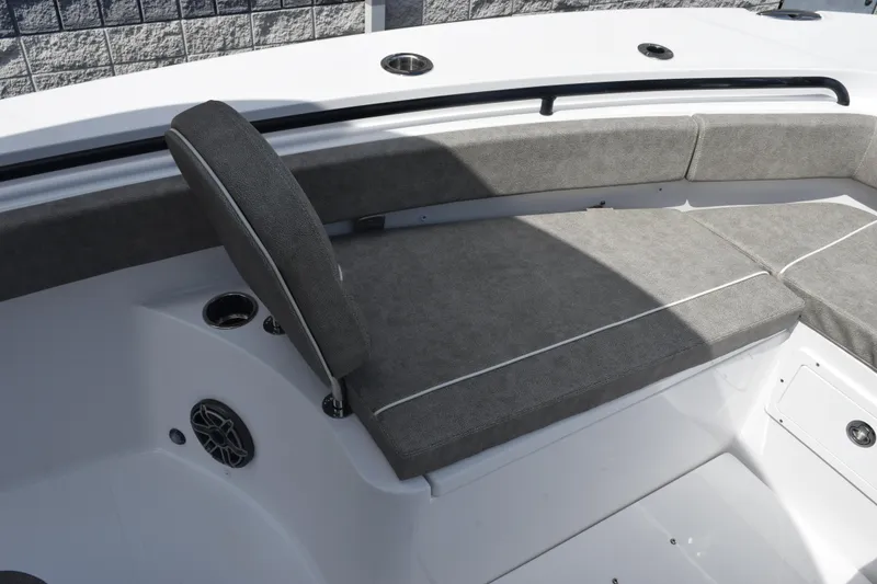 Slide: The Image of 2026 Sea Hunt Gamefish 25 boat interior with gray cushioned seating and cup holders. - 16