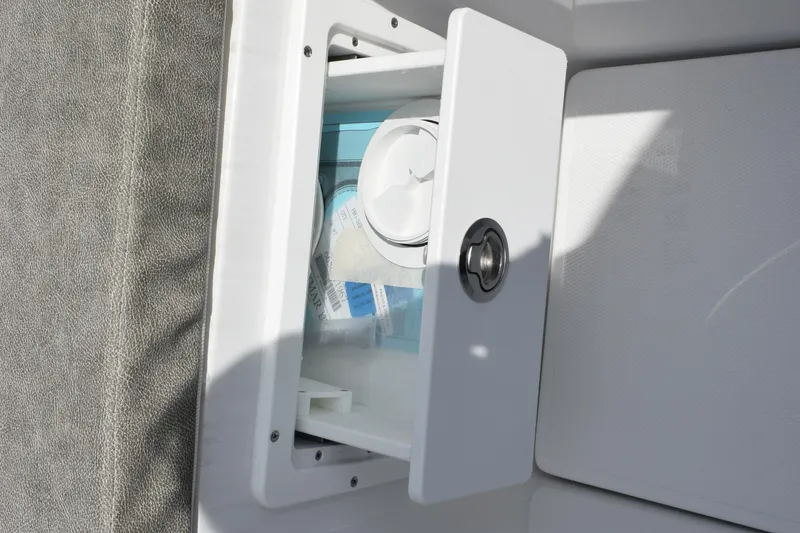Slide: The Image of Storage compartment on 2026 Sea Hunt Gamefish 25 boat, partially open with visible contents. - 17