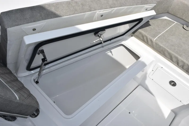 Slide: The Image of Open storage compartment on 2026 Sea Hunt Gamefish 25 boat, featuring cushioned seating. - 18