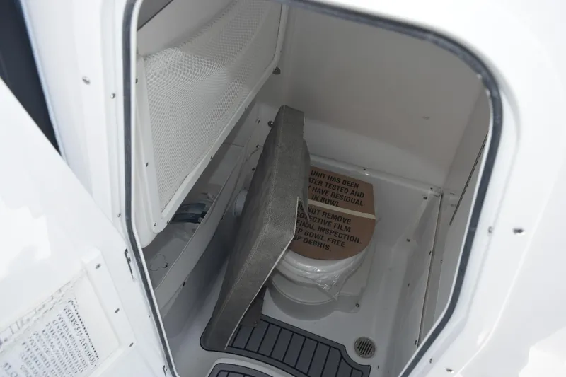 Slide: The Image of Interior of 2026 Sea Hunt Gamefish 25 boat, featuring a compact restroom area. - 19