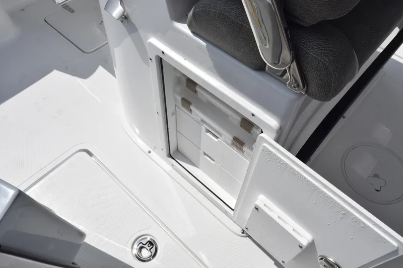 Slide: The Image of 2026 Sea Hunt Gamefish 25 boat interior storage compartment with open hatch and seating. - 25