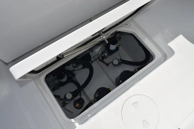 Slide: The Image of Open hatch of 2026 Sea Hunt Gamefish 25, revealing internal components and wiring. - 26