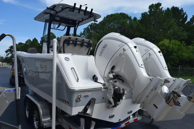 Slide: The Image of 2026 Sea Hunt Gamefish 25 boat with dual Yamaha outboard engines on a trailer. - 5