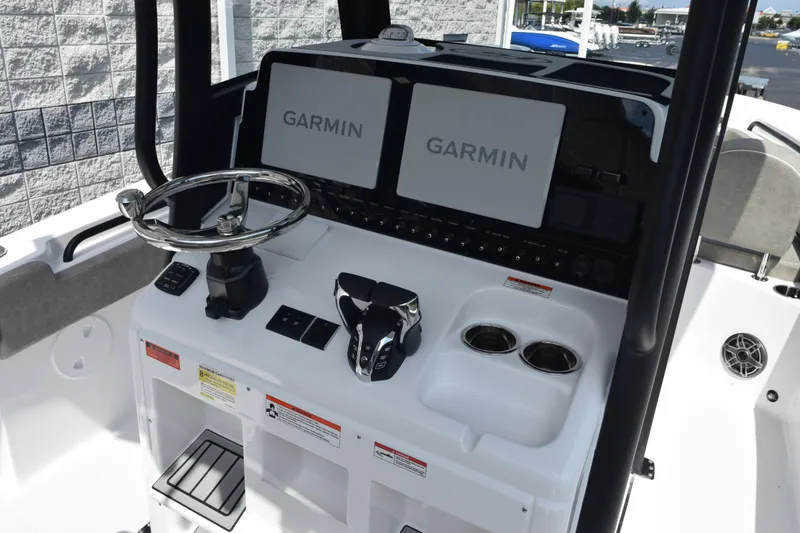 Slide: The Image of 2026 Sea Hunt Gamefish 25 boat console with Garmin displays and steering wheel. - 9