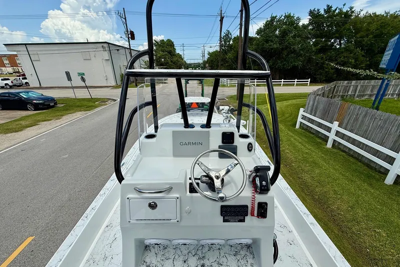 Slide: The Image of 2024 Shallow Sport 25 X3 boat console with Garmin navigation, parked on a street. - 10