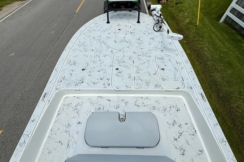Slide: The Image of 2024 Shallow Sport 25 X3 boat with marbled deck design on a road. - 13