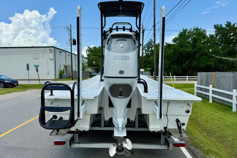 Slide: The Image of 2024 Shallow Sport 25 X3 boat with Suzuki 350 engine on trailer, street view. - 3