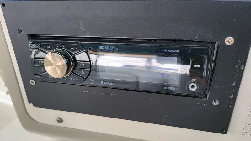 Slide: The Image of Close-up of a 1994 Maxum 3200 SCR boat stereo system with Bluetooth and USB features. - 10