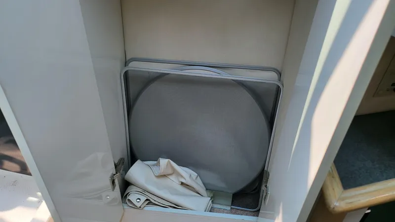 Slide: The Image of Storage compartment in a 1994 Maxum 3200 SCR boat with mesh screens and fabric. - 15