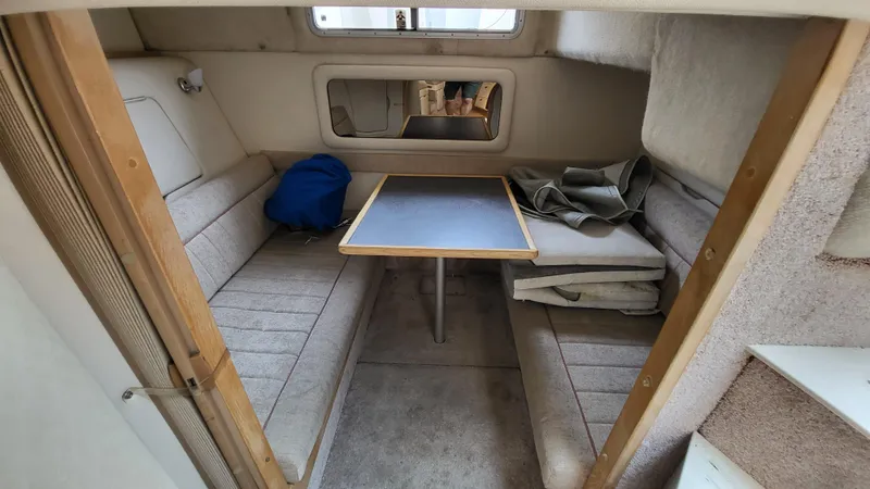 Slide: The Image of 1994 Maxum 3200 SCR cabin interior with seating, table, and window. - 17