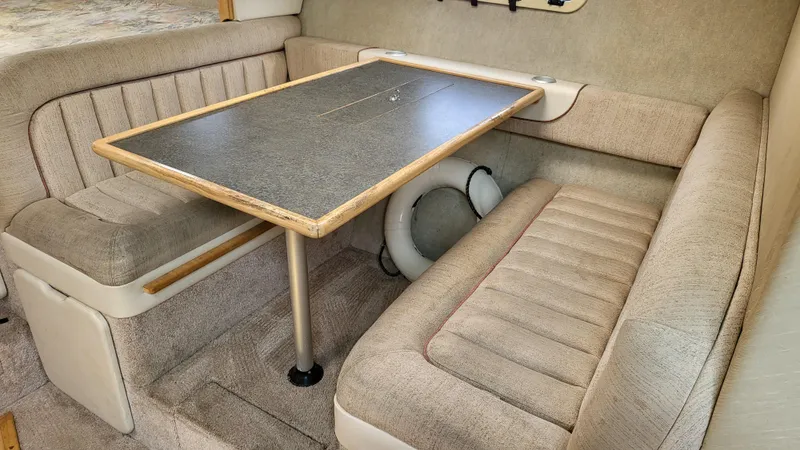 Slide: The Image of 1994 Maxum 3200 SCR interior with beige seating and a wooden table. - 18