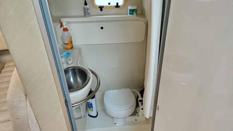 Slide: The Image of 1994 Maxum 3200 SCR boat bathroom with sink, toilet, and toiletries. - 21