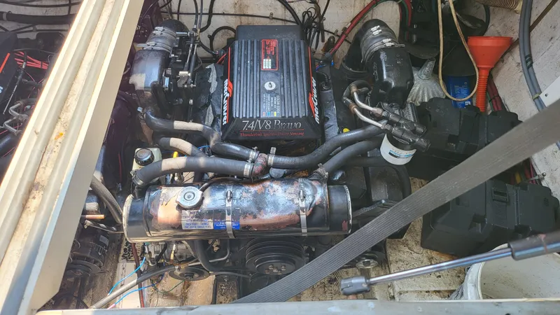 Slide: The Image of Engine compartment of a 1994 Maxum 3200 SCR boat, featuring a V8 engine. - 24