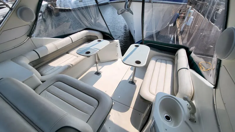 Slide: The Image of Spacious interior of 1994 Maxum 3200 SCR yacht with comfortable seating and tables. - 4