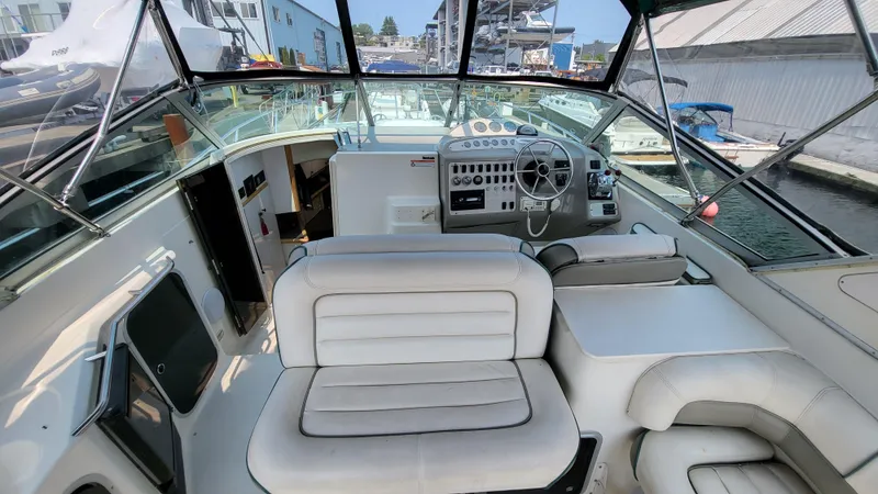 Slide: The Image of 1994 Maxum 3200 SCR boat interior with white seating and control panel. - 5