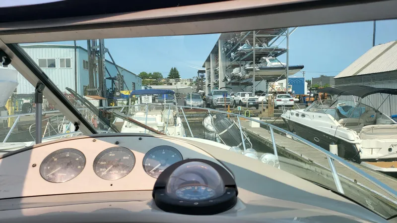 Slide: The Image of View from 1994 Maxum 3200 SCR boat cockpit at marina with multiple boats docked. - 8