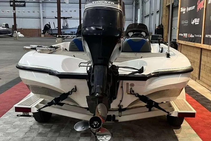 Slide: The Image of 2005 Nitro NX 750 boat with Tracker motor in a showroom. - 2