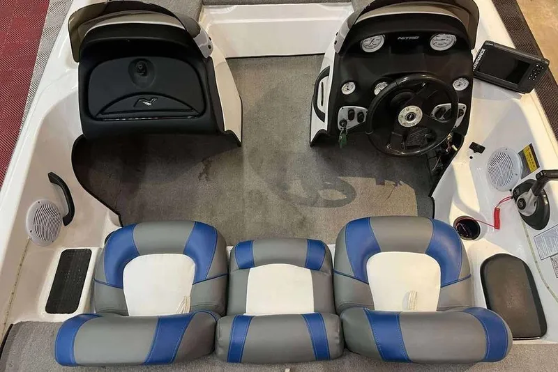 Slide: The Image of 2005 Nitro NX 750 boat interior with blue and gray seating, steering console, and dashboard controls. - 3