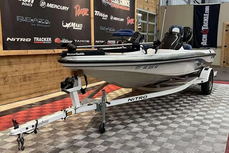 Slide: The Image of 2005 Nitro NX 750 boat on trailer in showroom, featuring MotorGuide equipment. - 5