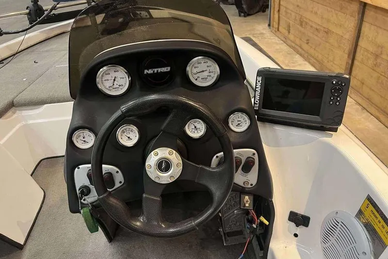 Slide: The Image of Dashboard of a 2005 Nitro NX 750 boat with steering wheel and Lowrance display. - 8