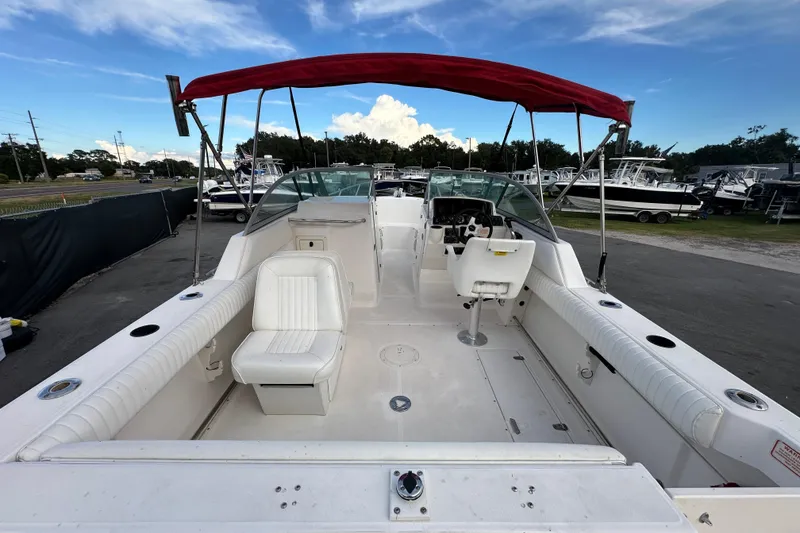 Slide: The Image of 2002 Boston Whaler 210 Ventura boat with red canopy, white seating, and spacious deck. - 14