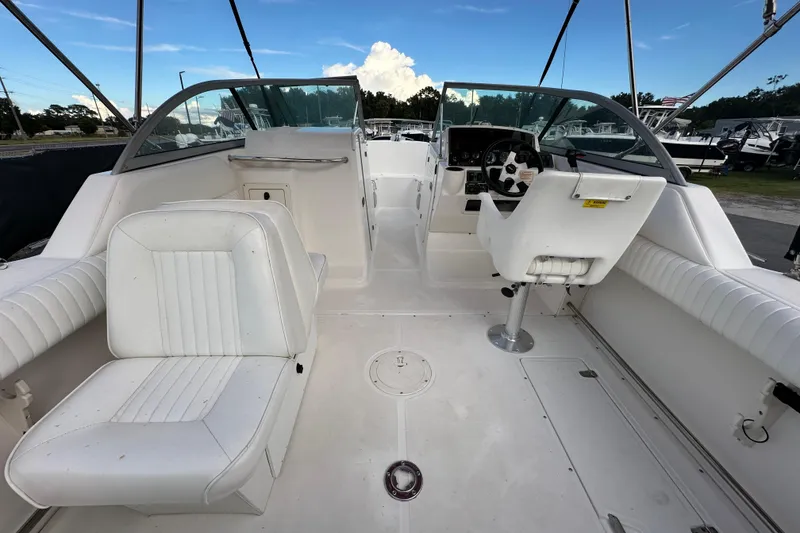 Slide: The Image of 2002 Boston Whaler 210 Ventura boat interior with white seating and steering console. - 17
