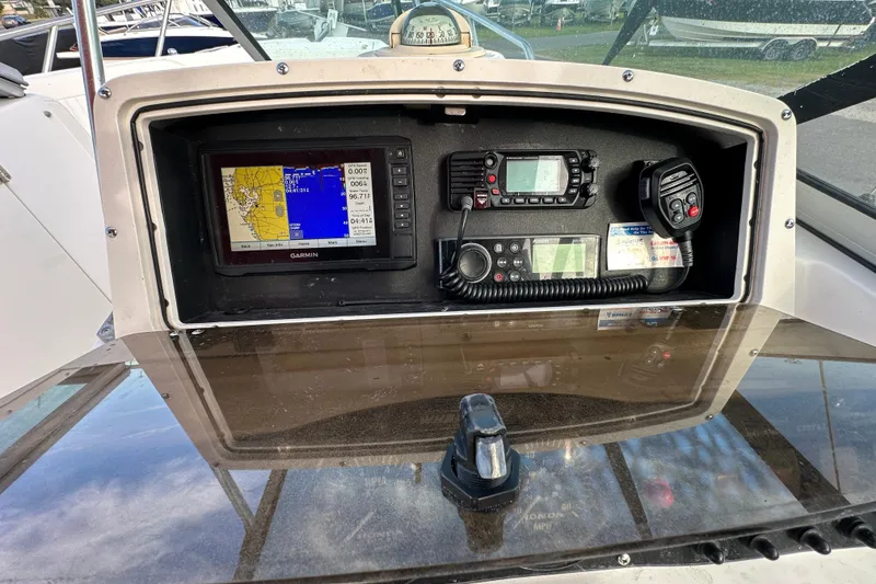 Slide: The Image of Control panel of a 2002 Boston Whaler 210 Ventura with navigation and communication equipment. - 24