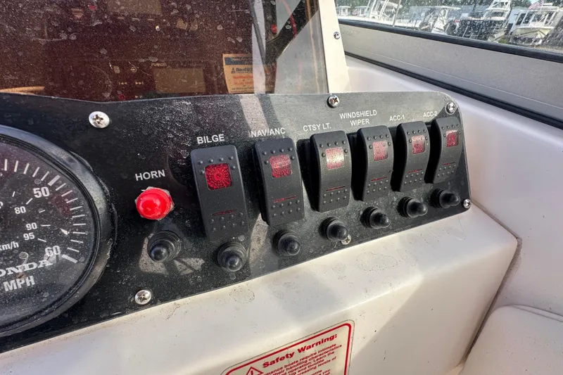 Slide: The Image of Control panel of a 2002 Boston Whaler 210 Ventura boat with switches and gauge. - 32