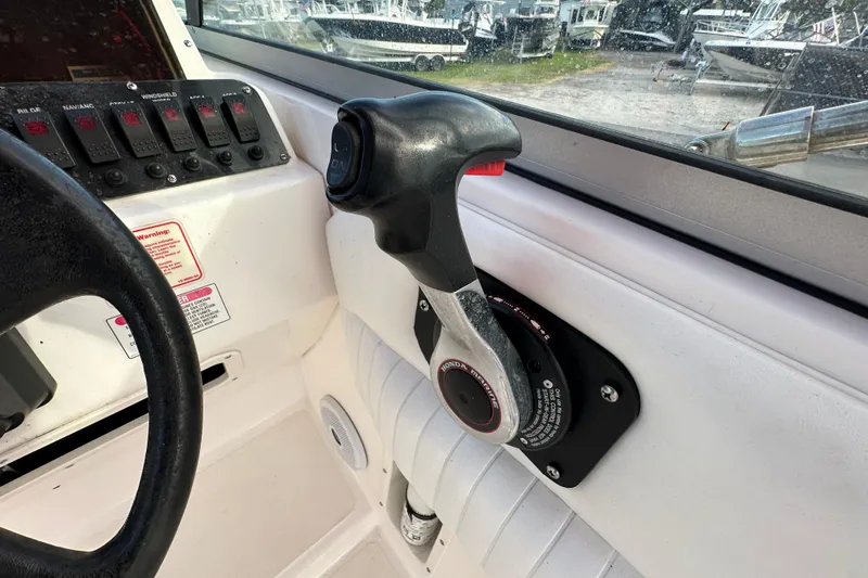 Slide: The Image of Control panel and throttle of a 2002 Boston Whaler 210 Ventura boat. - 33