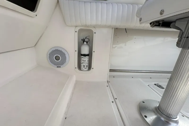 Slide: The Image of Interior of a 2002 Boston Whaler 210 Ventura with fire extinguisher and speaker. - 35