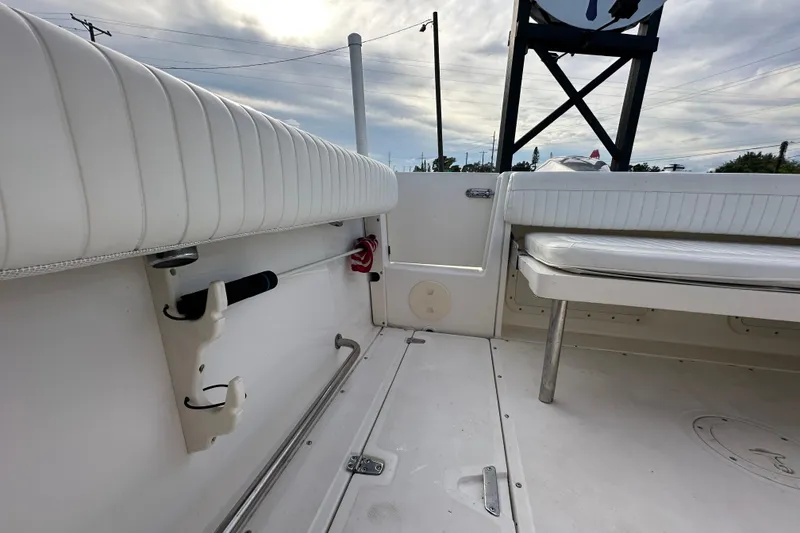 Slide: The Image of 2002 Boston Whaler 210 Ventura boat interior with white seating and storage compartments. - 37