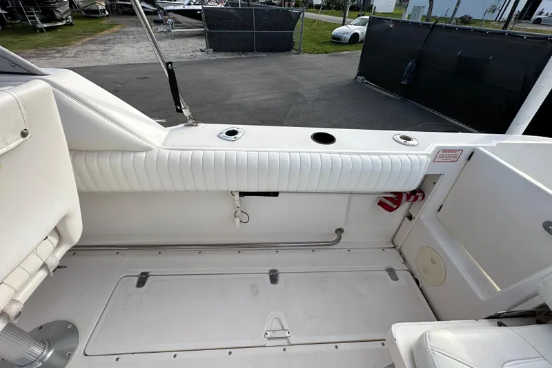 Slide: The Image of 2002 Boston Whaler 210 Ventura boat interior with white seating and storage compartments. - 38