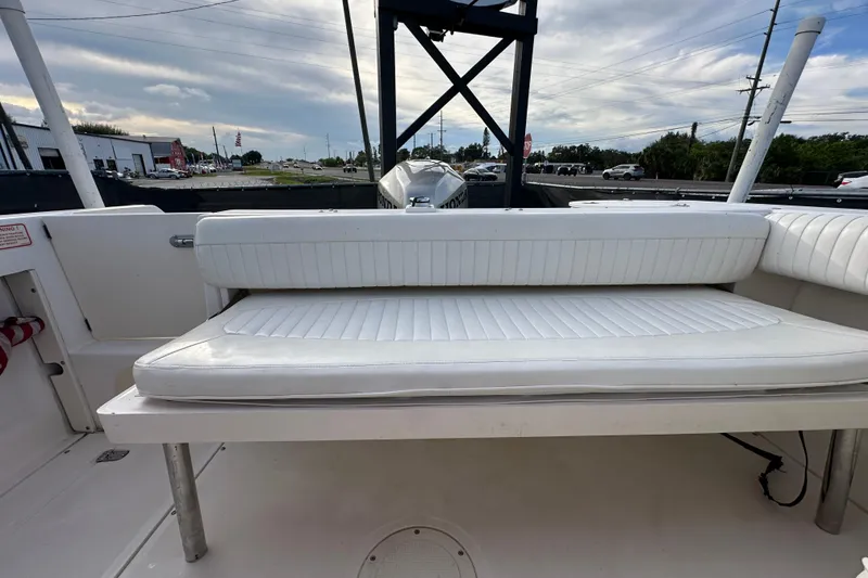 Slide: The Image of 2002 Boston Whaler 210 Ventura boat interior with white cushioned seating. - 42