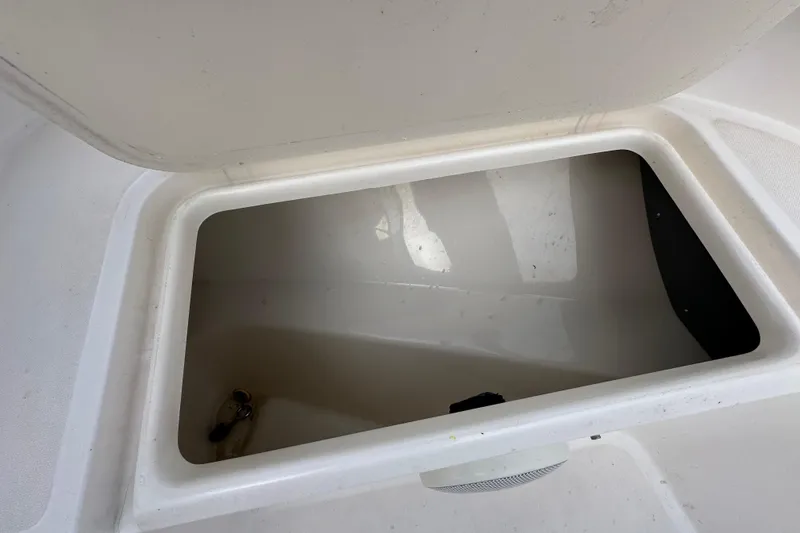 Slide: The Image of Open storage compartment on a 2002 Boston Whaler 210 Ventura boat. - 73