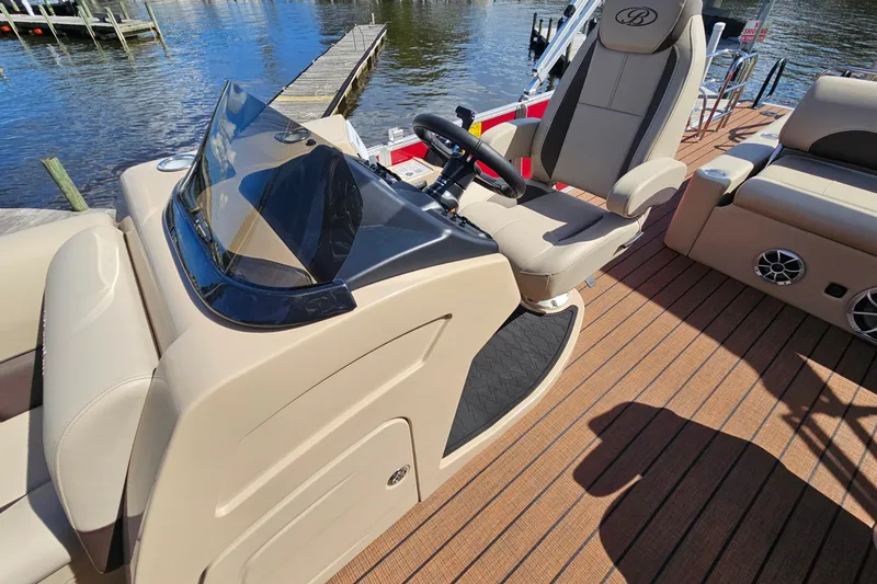 Slide: The Image of 2025 Bentley Pontoons Legacy 243 Swingback interior with steering console and seating. - 12