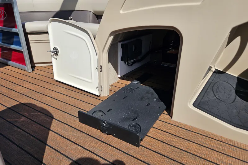 Slide: The Image of 2025 Bentley Pontoons Legacy 243 Swingback interior storage compartment with open door. - 13