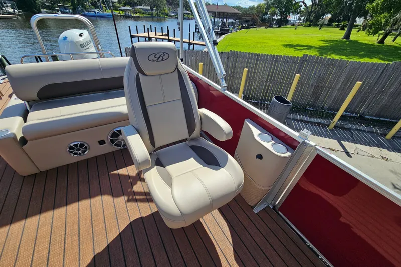 Slide: The Image of 2025 Bentley Pontoons Legacy 243 Swingback interior with luxurious seating and cup holders. - 17