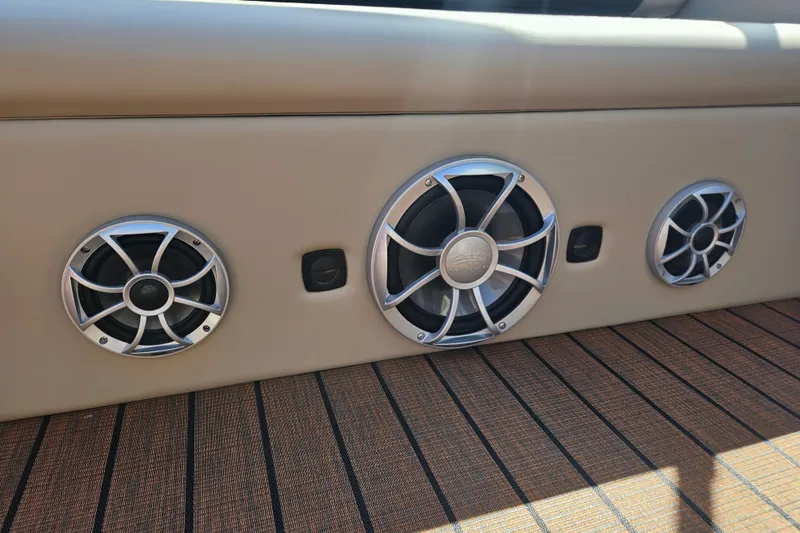 Slide: The Image of 2025 Bentley Pontoons Legacy 243 Swingback speakers on stylish deck flooring. - 20