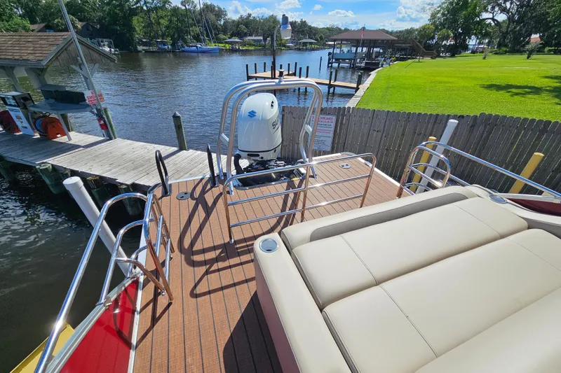 Slide: The Image of 2025 Bentley Pontoons Legacy 243 Swingback on a scenic waterfront dock. - 21