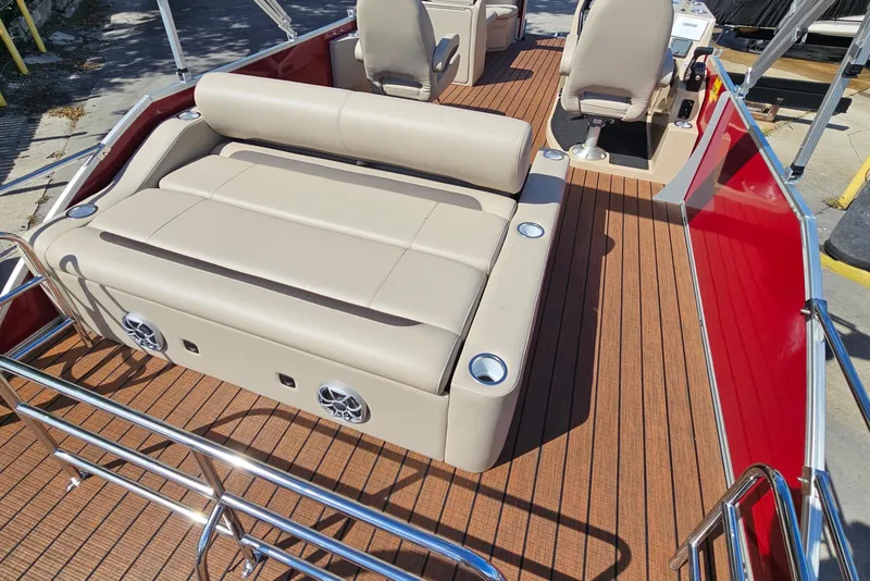 Slide: The Image of 2025 Bentley Pontoons Legacy 243 Swingback with beige seating and wood-style flooring. - 23