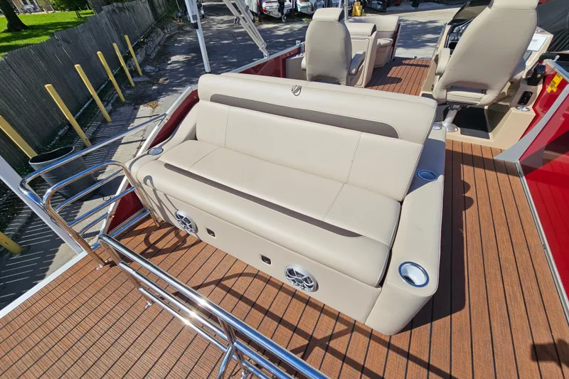 Slide: The Image of 2025 Bentley Pontoons Legacy 243 Swingback with beige seating and wood-style flooring. - 24