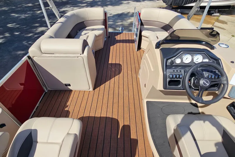 Slide: The Image of 2025 Bentley Pontoons Legacy 243 Swingback interior with luxurious seating and modern dashboard. - 28