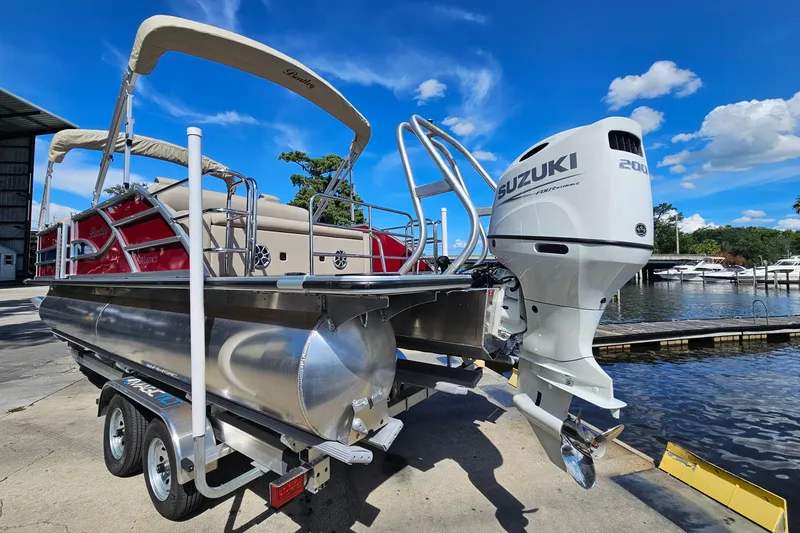 Slide: The Image of 2025 Bentley Pontoons Legacy 243 Swingback with Suzuki engine at marina dock. - 3