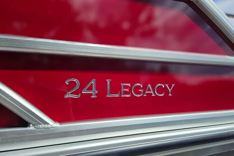 Slide: The Image of Close-up of 2025 Bentley Pontoons Legacy 243 Swingback logo on red background. - 33