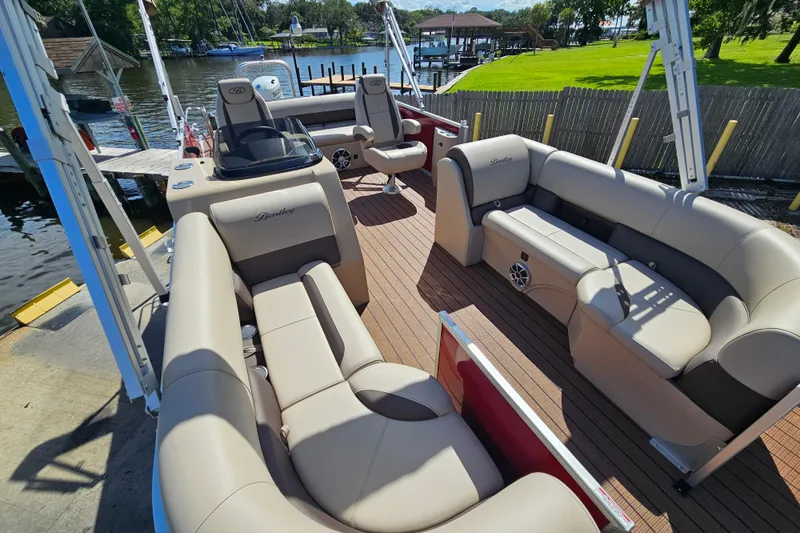 Slide: The Image of 2025 Bentley Pontoons Legacy 243 Swingback with luxurious seating on a sunny dock. - 8